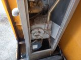 a small engine that is sitting in the corner of a building