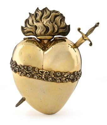 an image of a golden heart shaped box with a sword sticking out of it
