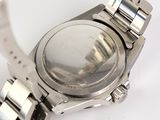 a watch that is sitting on a white surface