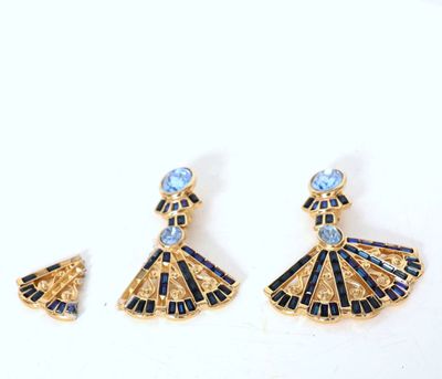 a close up of a pair of earrings on a white surface