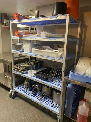 a metal shelf with a bunch of dishes on it