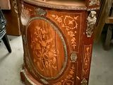 a wooden cabinet that has a mirror on top of it