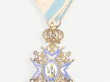 a close up of a medal on a white background with a blue ribbon