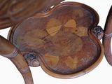 a close up of a wooden chair with a floral design on it