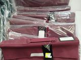 many bags of luggage sitting on a table in a store