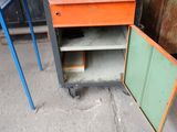 a small cabinet with a laptop on top of it next to a small table with a laptop on top of it