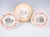 three plates with different designs on them sitting next to each other