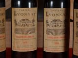 three bottles of red wine are lined up on a table