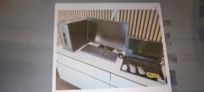 a picture of a picture of a desk with two computers on it