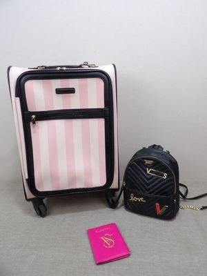 two pieces of luggage sitting on the floor next to each other