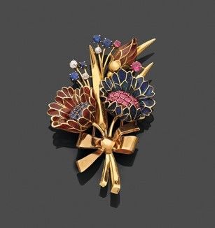 une image représentant une broche ornée de fleurs et de rubans sur un fond noir