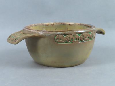 a small bowl with a spoon in it on a table
