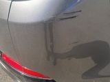 a close up of a car ' s rear end with the tail light on