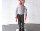 a picture of a doll that is on a pedestal