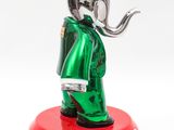 statue of an elephant with a red hat and a green coat