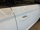 a white car with a sticker on the side of it