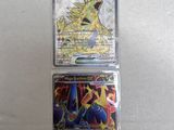 a couple of pokemon cards sitting on top of a table
