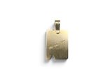 a close up of a gold pendant on a white surface