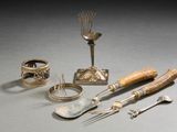 a silverware set with spoons, forks, and spoon rest