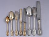 a lot of silver spoons and silverware on the table