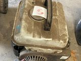 a small lawn mower sitting on the floor next to a wheel