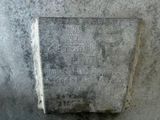 a stone plaque on the side of a building