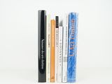 several books are stacked on top of each other on a white surface
