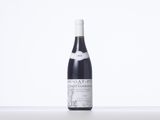a bottle of red wine sitting on a table