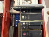 many books in a red box on a table