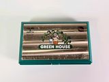 a box of green house cigarettes sitting on a table