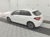 a picture of a white car parked in a garage
