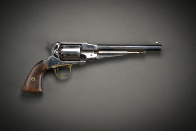a close up of a revolver on a gray background
