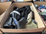 many boxes of clothes that are sitting on the floor