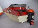 a red and white boat next to a white and orange boat