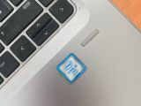 a close up of a laptop with a blue sticker on the keyboard