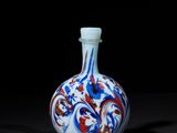 chinese blue and white snuff bottle with red, white, and blue swirl design