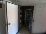 a door that is open in a room with a shelf
