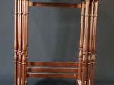 an image of a small wooden table on a grey background