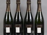three bottles of champagne sitting on a table next to each other
