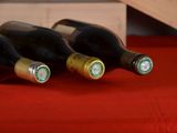 three bottles of wine sitting on a red table