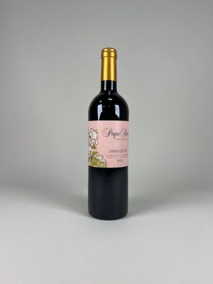 a bottle of wine sitting on top of a white table