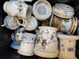 many cups and mugs that are sitting on a shelf