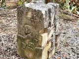 a large stone block sitting in the middle of a garden