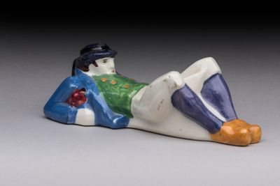 a figurine of a man laying down on the ground