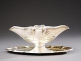 a silver plate with a silver saucer on it