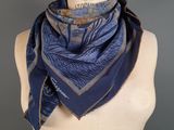 a close up of a mannequin torso with a blue scarf on it