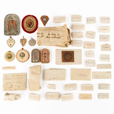 several pieces of old paper and other items on a white surface