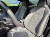 the interior of a car with a leather seat and a steering wheel
