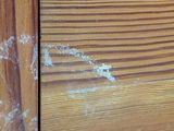 a close up of a wooden door with peeling paint on it