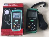 a box with a digital light meter on the table